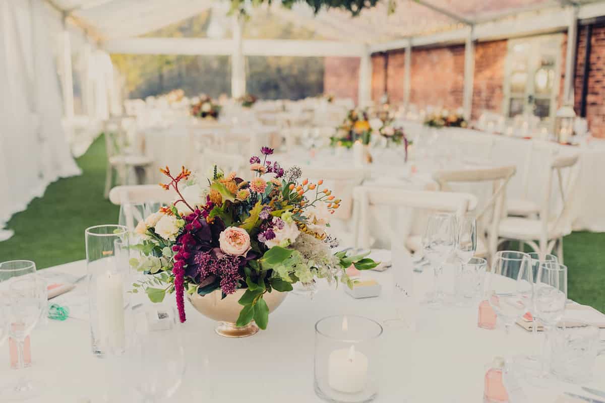 A colourful table centre in a wedding marquee